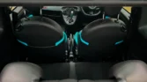 Rear view of Fiat 500 interior, showing back of front seats with black and turquoise trim and rear headrests.